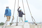 Workers carefully secure the wire.