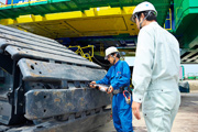 Sake is ritually poured over the crane and the four sides of the crawlers.